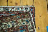 Vintage Persian Hamadan rug corner with geometric blue, red, and cream patterns.