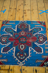 Antique Caucasian fragment with expressive red and blue asymmetrical geometric patterns.