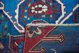 Expressive red and blue geometric patterns on an antique Caucasian rug's pile and hand-knotted reverse.