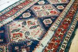 Distressed pile with geometric patterns and original selvage of an antique Caucasian runner.