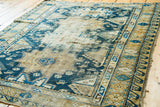 Distressed blues and light beige geometric patterns on an antique Caucasian Shirvan rug.