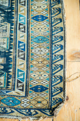 Distressed early 20th century Caucasian Shirvan rug, fine geometric blue and beige patterns.
