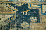 Stylized tan animal motif and geometric patterns on distressed antique Caucasian Shirvan.