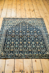 Intricate prayer arch design of the fine antique Farahan Sarouk with navy, teal, and ivory motifs.
