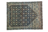 Antique Persian Farahan Sarouk rug with fragmented floral design, deep navy charcoal field and ivory accents.