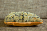Side profile of the antique Caucasian fragment pillow, geometric pattern, and vibrant orange velvet.