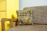 Handmade antique Caucasian fragment pillow with orange, yellow, and blue geometric motif.