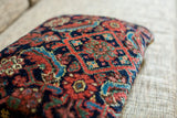 Intricate dark blue and red Mahal Persian pattern on the soft wool pillow surface.