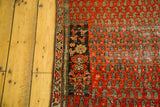 Unique charcoal tree of life and birds in cartouche on distressed antique Malayer rug.