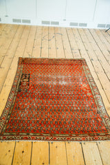 Distressed lower corner of antique Persian Malayer rug showing unique tree-of-life motif.