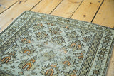 Distressed pile of antique Caucasian rug, earth tone lotus flowers and star border.