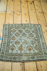 Antique Caucasian rug corner, geometric patterns, star border, distressed earth tones and orange pops.
