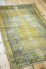 Distressed gold pile, faded Ladik style borders, and end fringe of a Turkish rug.