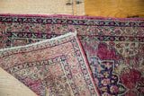 Late 19th-century Kerman rug showing distressed deep red pile and woven back foundation.