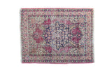 Distressed antique Persian Kerman rug mat with large navy medallion, faded red floral patterns. 1'11