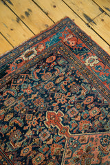 Detailed view of the antique Bijar rug's herati field and Morris style floral border.