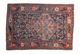 Antique Persian Bijar rug, navy field, central salmon medallion, allover Herati, rust floral border.