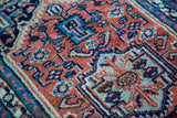 Hand-knotted Herati-inspired design in oxidized copper, deep blue, and light hues.