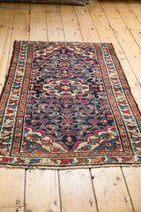 Textured fringe and terracotta border with floral bouquets on the dark blue Lilihan rug.