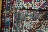 Close-up of the vintage Hamadan rug's tight hand-knotted foundation and detailed border.