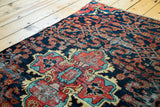 Vintage Dargazine rug fragment: red and sky blue medallion with navy Herati field.