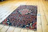 Vintage Dargezine rug fragment with expressive center medallion and red, sky blue Herati design on navy field.