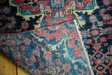 Close-up of a vintage Dargezine rug fragment, hand-knotted pile, Herati pattern, sky blue, secured edge.