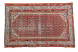 Distressed antique Persian Serbend rug with rust field and allover blue, ivory repeating motifs.