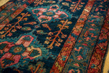 Deep indigo field with bold gem-tone medallion, germinating plants, and rust border on vintage Hamadan rug.