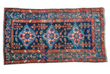 Vintage Persian Hamadan runner with dark blue field, gem-tone geometric medallions, and rust borders.
