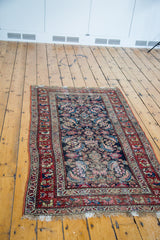 Distressed dark blue field with faded herati pattern and worn red border.