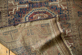 Antique Belouch rug detail: hand-knotted pile, geometric patterns, woven foundation, and secured side.