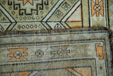 Vintage Caucasian rug's secured side and tightly woven reverse with tribal motifs.