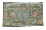 Vintage Caucasian rug featuring triple geometric medallions in pale green, ivory, charcoal, orange.