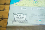 Vintage New York map detail: central panel with state facts, symbols, and pastel vignettes.