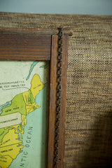 Antique folk art map corner with dark wood frame, metal chain, and colorful northeastern states.