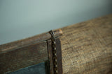 Rustic dark wood frame and metal chain on antique map painting.