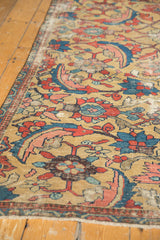 Antique Persian Sultanabad rug close-up: unique gold field with red and blue serrated leaf designs.