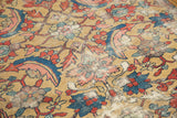 Antique Sultanabad carpet detail: textured gold field with dramatic red and blue serrated leaf motifs.