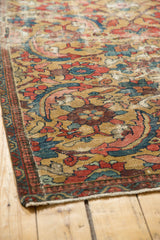 Textured gold field of early 20th century Sultanabad carpet with bold serrated leaf motifs.