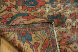 Folded antique Persian Sultanabad Mahal rug, revealing secured edges and hand-knotted serrated leaf design.