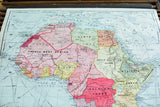 1938 Cram's pulldown map of Africa, detailing its geography and subdued colors on canvas.
