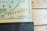 Vintage 1938 Cram's map detail showing Australia, copyright text, and worn edge.