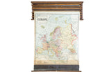 Vintage 1938 Cram's pull-down map of Europe, featuring subdued colors and wood casing.