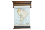 Cram's 1938 vintage pull-down map of South America, with subdued colors and original wood hardware.