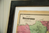 Upper left of antique Bedford, NY map showing prominent tear and black frame.