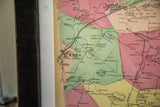 Detail of antique Bedford, New York map showing colored land sections and aged paper.