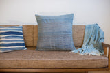 Handwoven 24x24 vintage indigo pillow displaying subtle thin white stripes.