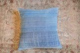 Indigo blue pillow fabric with subtle white stripes and handwoven texture.