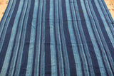 Vintage handwoven indigo blue striped textile with nuanced color tones and subtle texture.